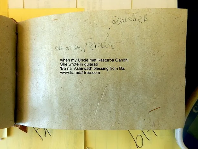 Open book showing a handwritten blessing attributed to Kasturba Gandhi